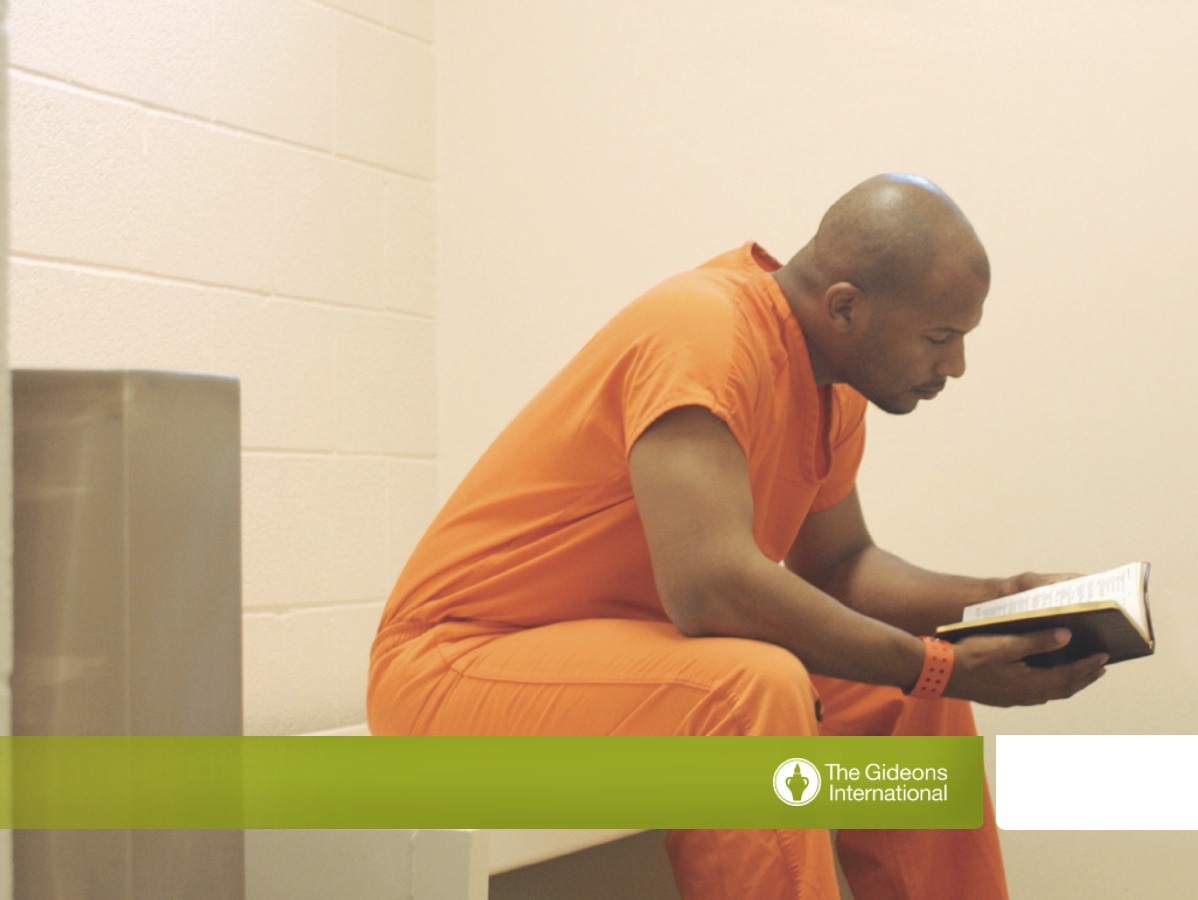 Prisoner reading Bible